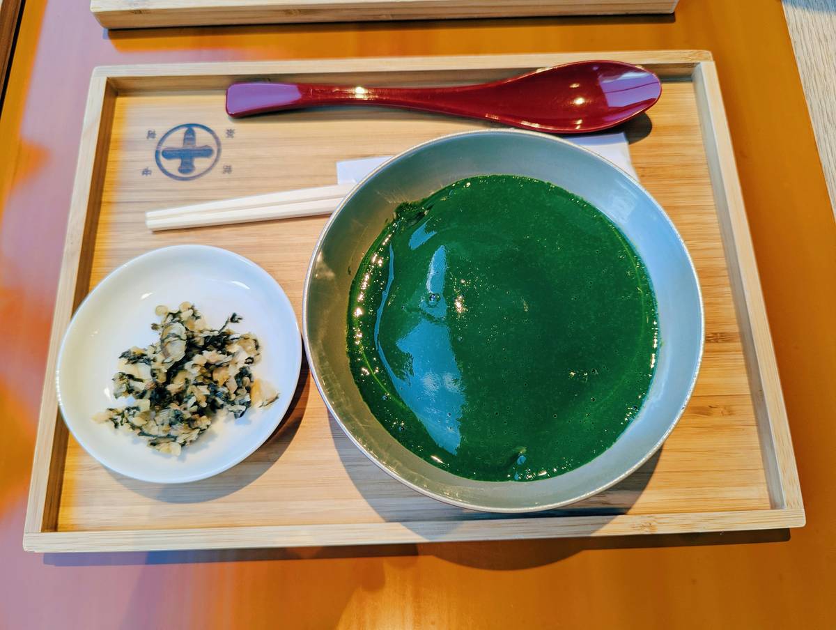 A close-up photo of bright green chaetomorpha seaweed floating in clear water.